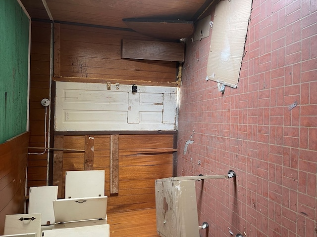 interior space featuring wooden ceiling and wood walls