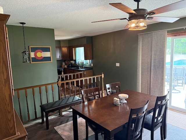2515 N E St, Kirksville, MO 63501 - dining room featuring a ceiling fan, a textured ceiling, and wood finished floors