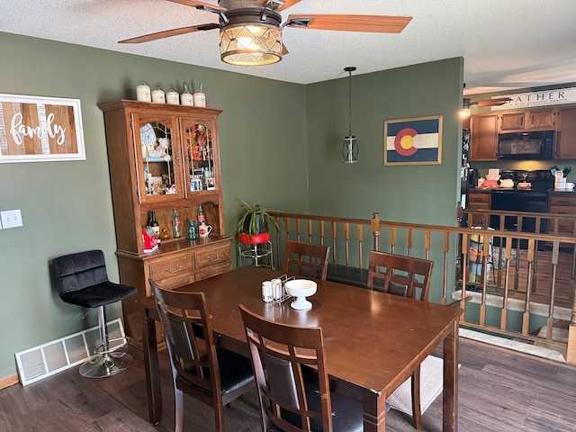 2515 N E St, Kirksville, MO 63501 - dining room with a ceiling fan, wood finished floors, baseboards, and a textured ceiling