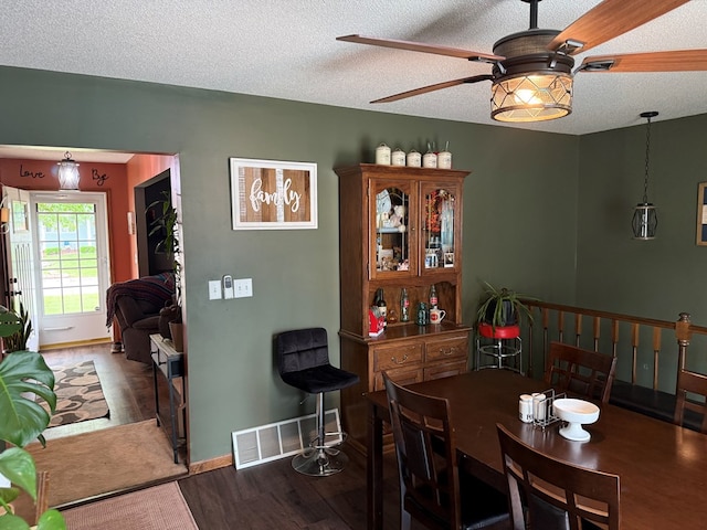 2515 N E St, Kirksville, MO 63501 - dining room with a ceiling fan, wood finished floors, a textured ceiling, and baseboards