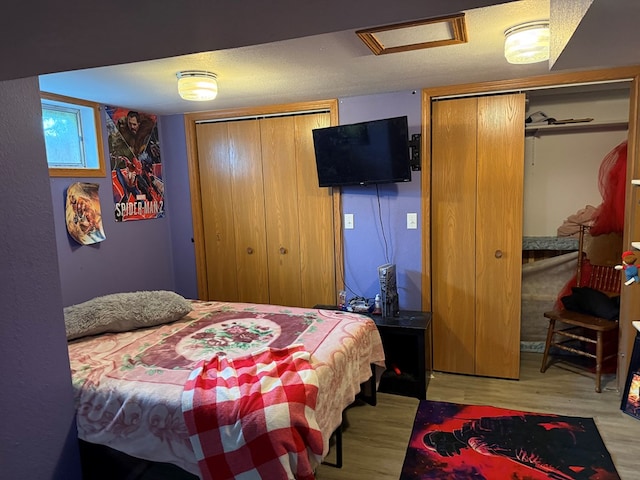 2515 N E St, Kirksville, MO 63501 - bedroom featuring multiple closets, wood finished floors, and attic access
