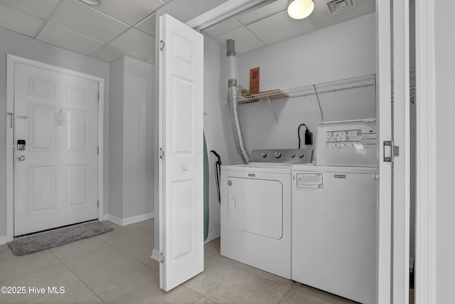 washroom with light tile patterned floors, visible vents, laundry area, and washer and dryer