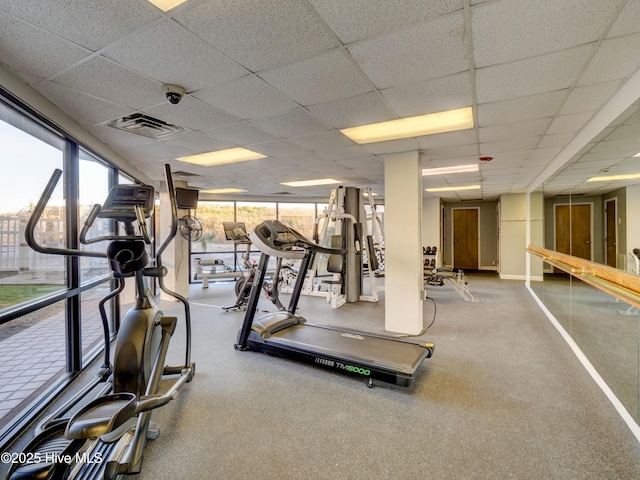 workout area featuring visible vents and a paneled ceiling
