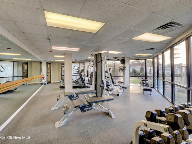 workout area featuring a healthy amount of sunlight, a drop ceiling, and visible vents