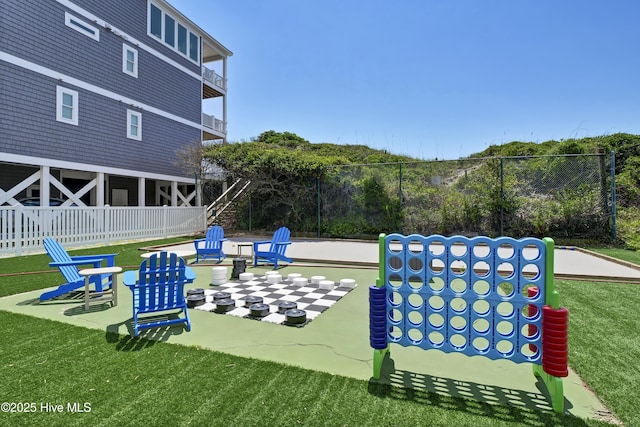 view of property's community featuring fence and a lawn