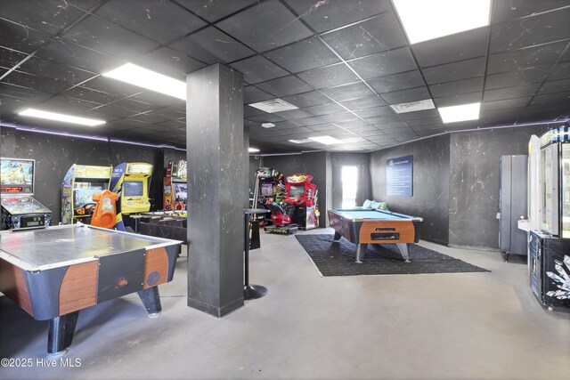 game room featuring finished concrete floors, billiards, and a drop ceiling