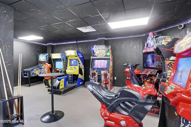game room featuring visible vents, concrete floors, and a drop ceiling