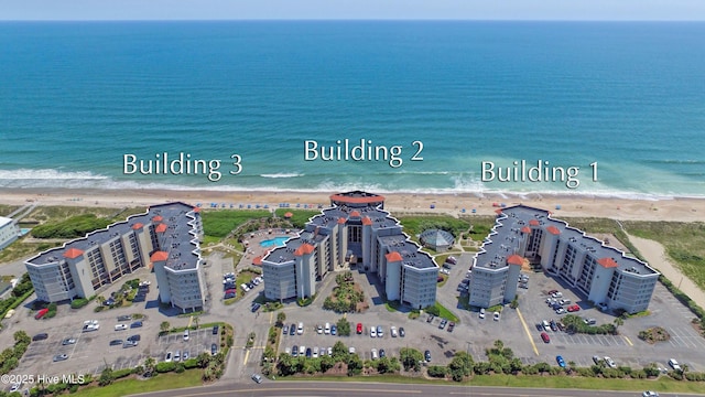 drone / aerial view featuring a water view and a view of the beach