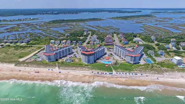 drone / aerial view with a water view and a beach view