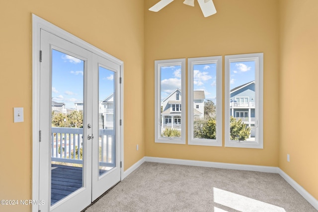 doorway to outside with plenty of natural light, french doors, ceiling fan, and light carpet