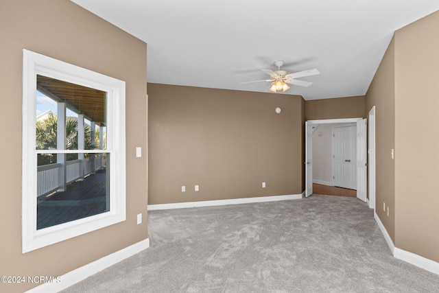 empty room featuring light carpet and ceiling fan