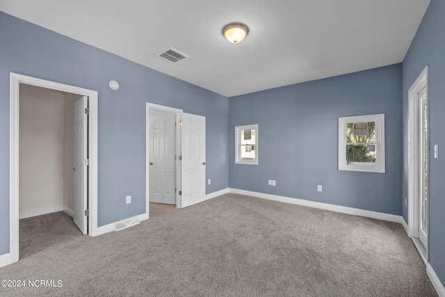 unfurnished bedroom featuring light colored carpet