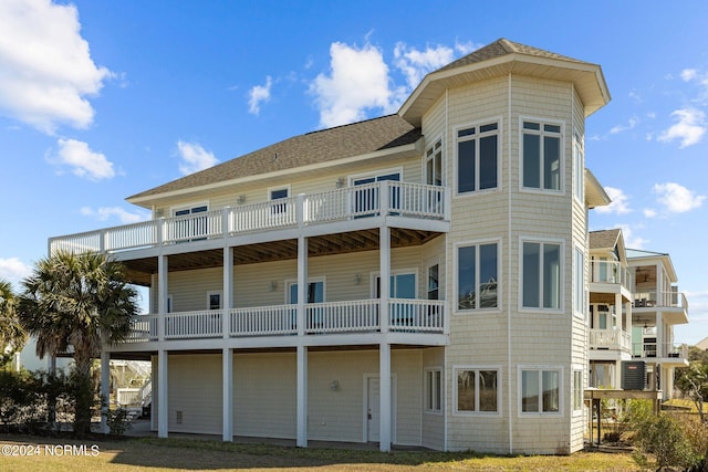 back of property with a balcony and central air condition unit