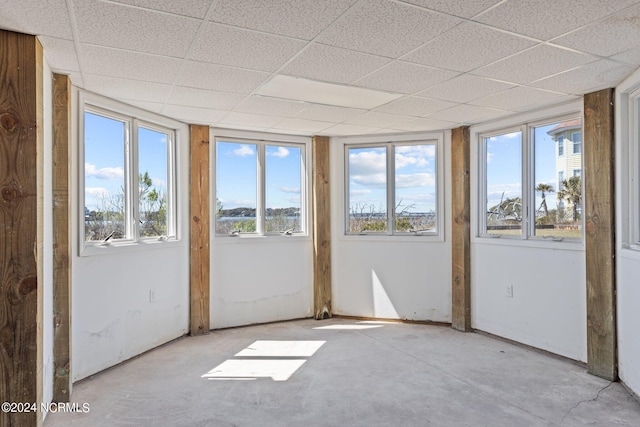 unfurnished sunroom with a drop ceiling