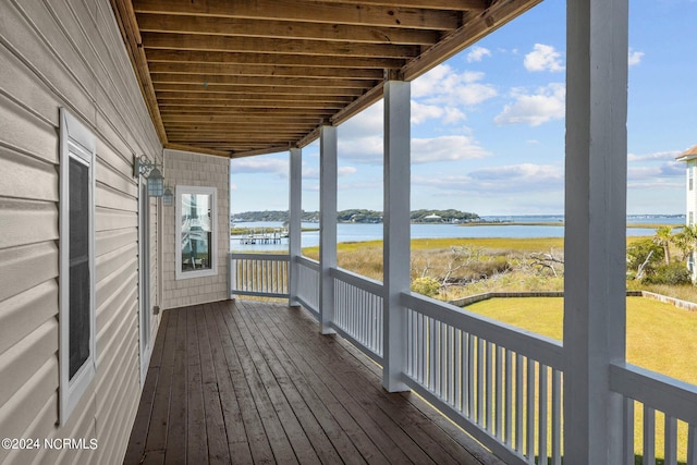 wooden terrace featuring a water view