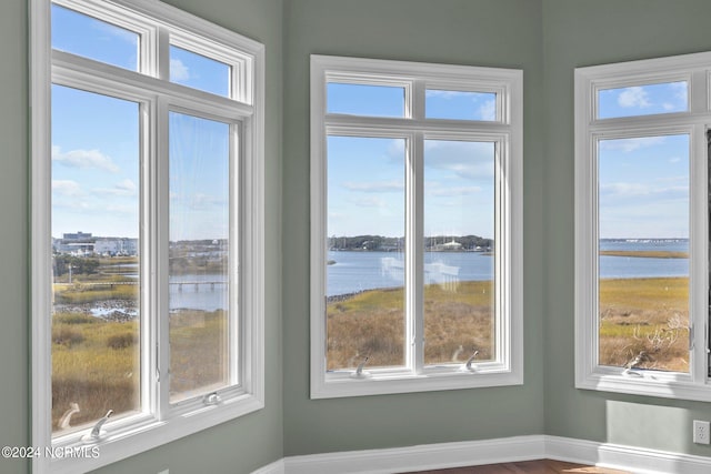 unfurnished sunroom with a water view