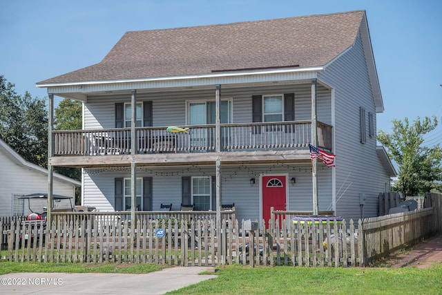 view of front of house featuring a balcony