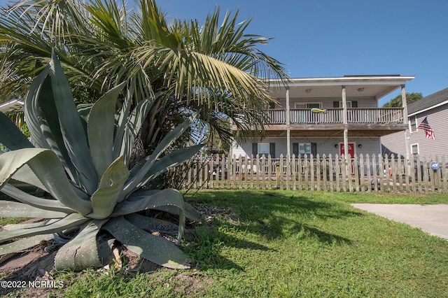 exterior space featuring a balcony and a lawn