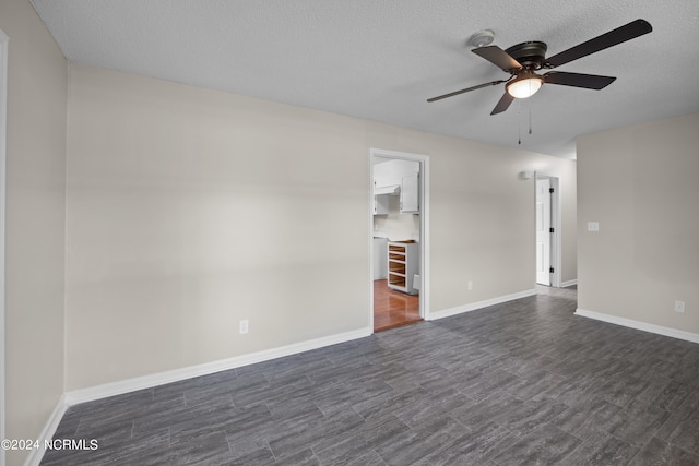 empty room with dark hardwood / wood-style floors, ceiling fan, and a textured ceiling