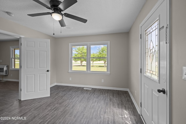 foyer featuring a healthy amount of sunlight, dark hardwood / wood-style flooring, ceiling fan, and a textured ceiling