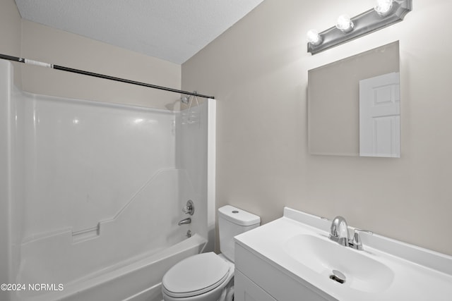 full bathroom with shower / washtub combination, oversized vanity, toilet, and a textured ceiling