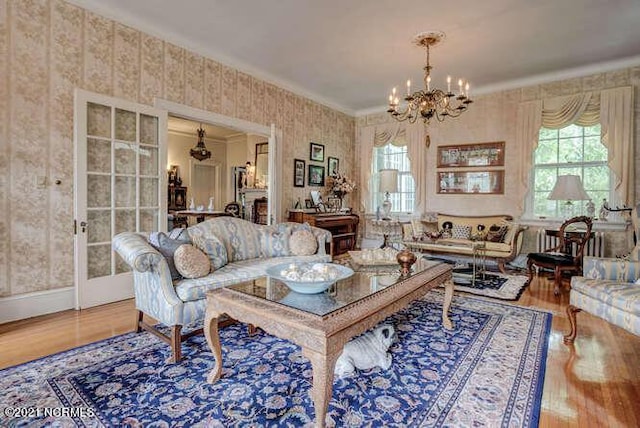 interior space with an inviting chandelier, crown molding, and light hardwood / wood-style floors