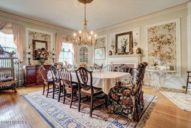 dining space with plenty of natural light, light hardwood / wood-style floors, and a chandelier