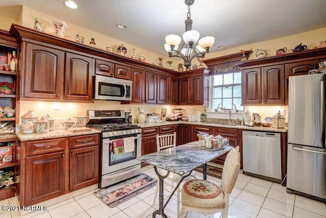 kitchen featuring an inviting chandelier, hanging light fixtures, stainless steel appliances, and light tile flooring