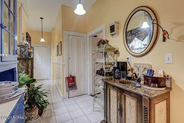entrance foyer featuring a fireplace, light tile floors, and sink