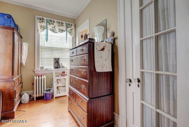 interior space with light hardwood / wood-style floors and radiator heating unit