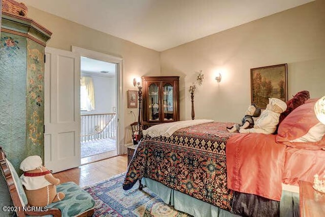 bedroom featuring light hardwood / wood-style floors and access to exterior