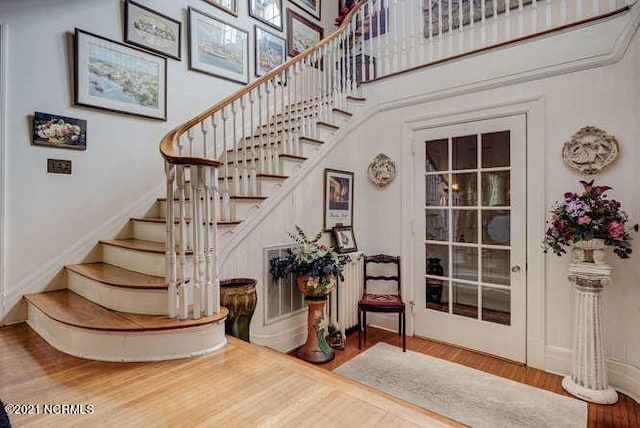 stairway with light hardwood / wood-style floors
