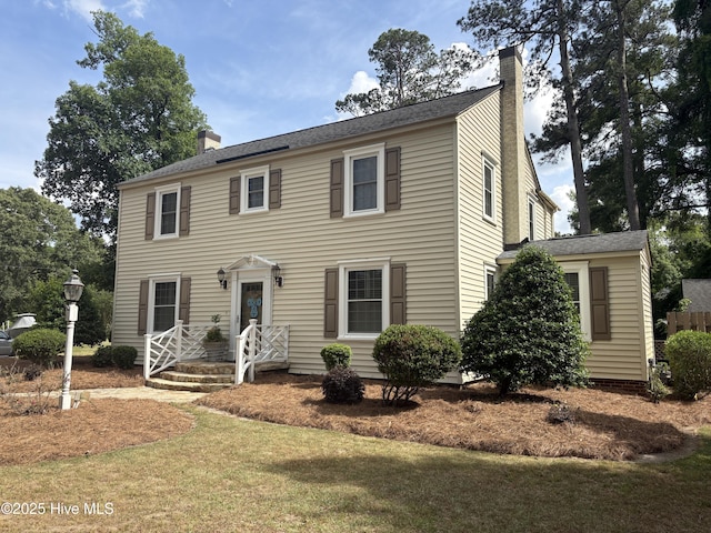 101 Spruce St, Washington, NC 27889 - colonial house featuring a chimney and a front yard