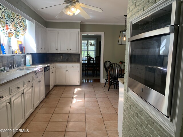 101 Spruce St, Washington, NC 27889 - kitchen featuring a sink, appliances with stainless steel finishes, white cabinetry, tasteful backsplash, and crown molding