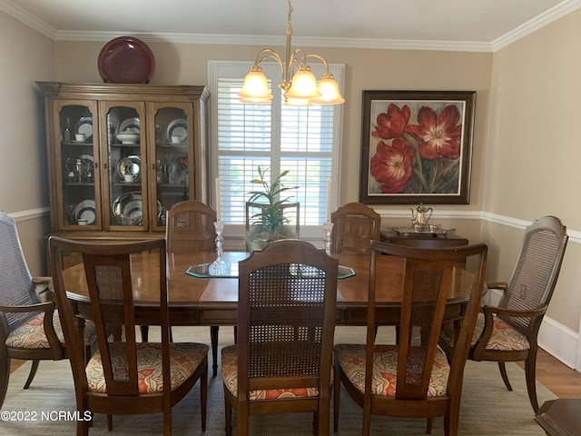 101 Spruce St, Washington, NC 27889 - dining room with a chandelier, ornamental molding, wood finished floors, and baseboards