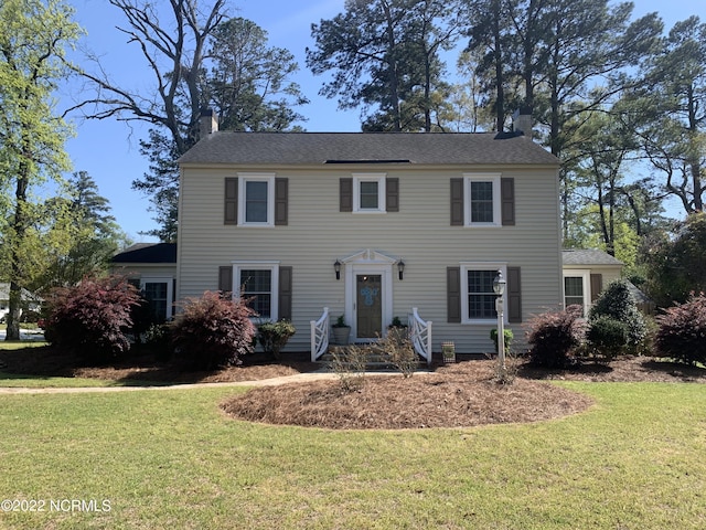 101 Spruce St, Washington, NC 27889 - colonial inspired home featuring a chimney and a front lawn