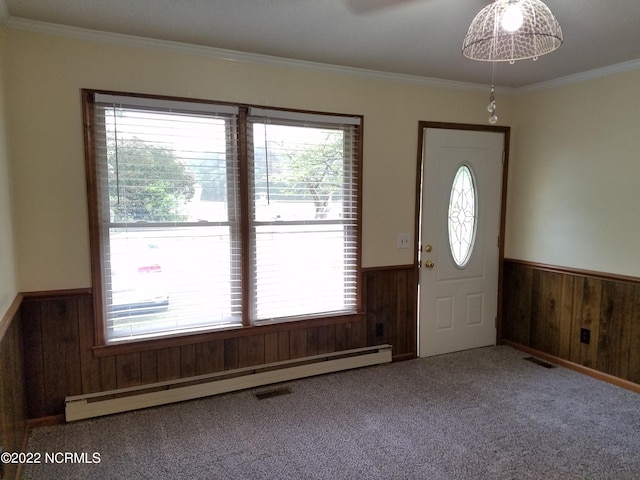 entrance foyer featuring light colored carpet, a baseboard heating unit, and crown molding