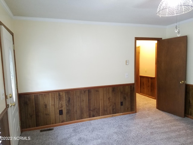 carpeted spare room with ornamental molding