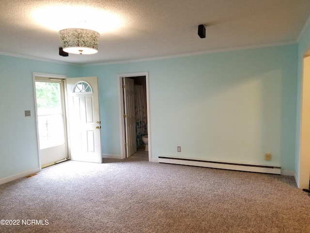 carpeted spare room with a baseboard heating unit, a textured ceiling, and ornamental molding