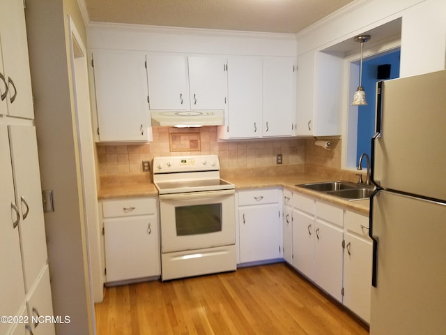 kitchen with light hardwood / wood-style flooring, hanging light fixtures, white appliances, and white cabinets