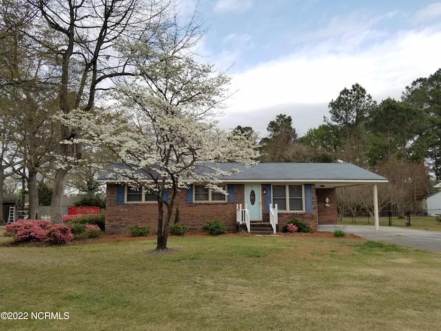 view of front facade with a carport and a front lawn