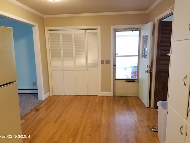 hall with light hardwood / wood-style floors, a baseboard radiator, and a wealth of natural light