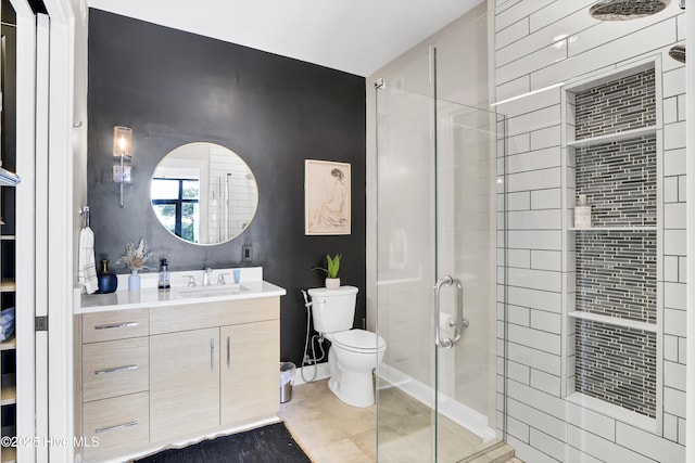 full bathroom featuring toilet, a shower stall, and vanity