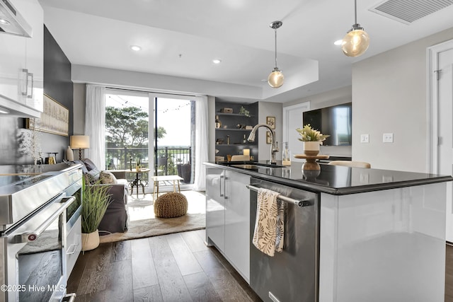 kitchen with dark countertops, a sink, dishwasher, dark wood finished floors, and visible vents