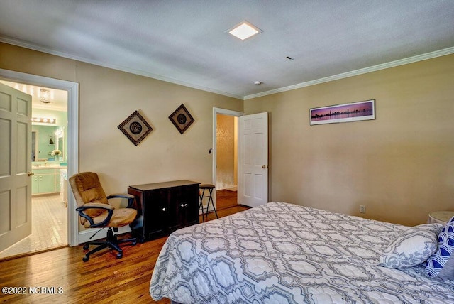 bedroom featuring ornamental molding, dark hardwood / wood-style floors, and ensuite bath