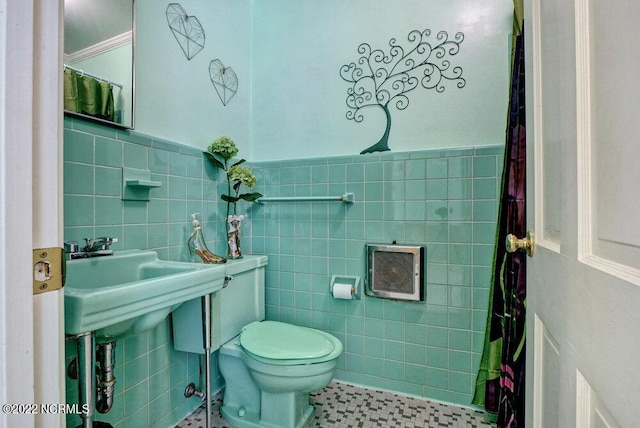 bathroom featuring tile walls, toilet, and tile floors