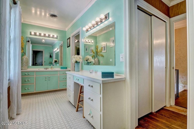 bathroom with ornamental molding, vanity, and tile flooring