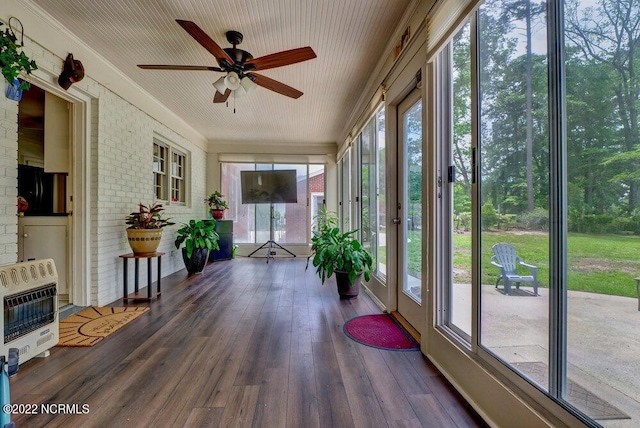 unfurnished sunroom featuring ceiling fan and a wealth of natural light