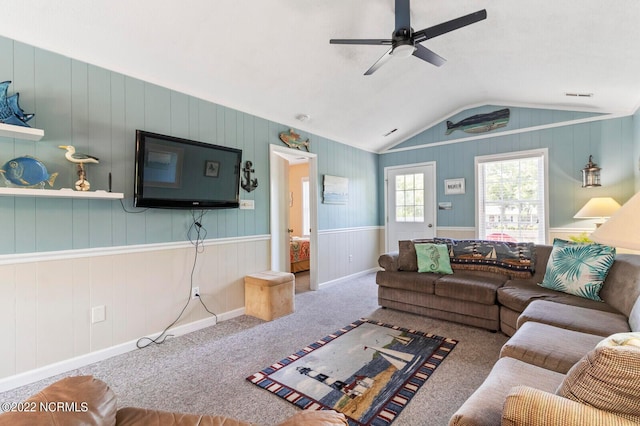 living room with carpet floors, ceiling fan, and vaulted ceiling