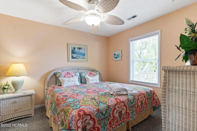 bedroom featuring ceiling fan and dark colored carpet